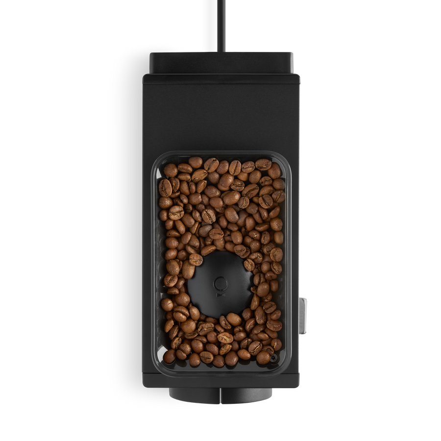 Fellow Ode coffee grinder in black top view with coffee